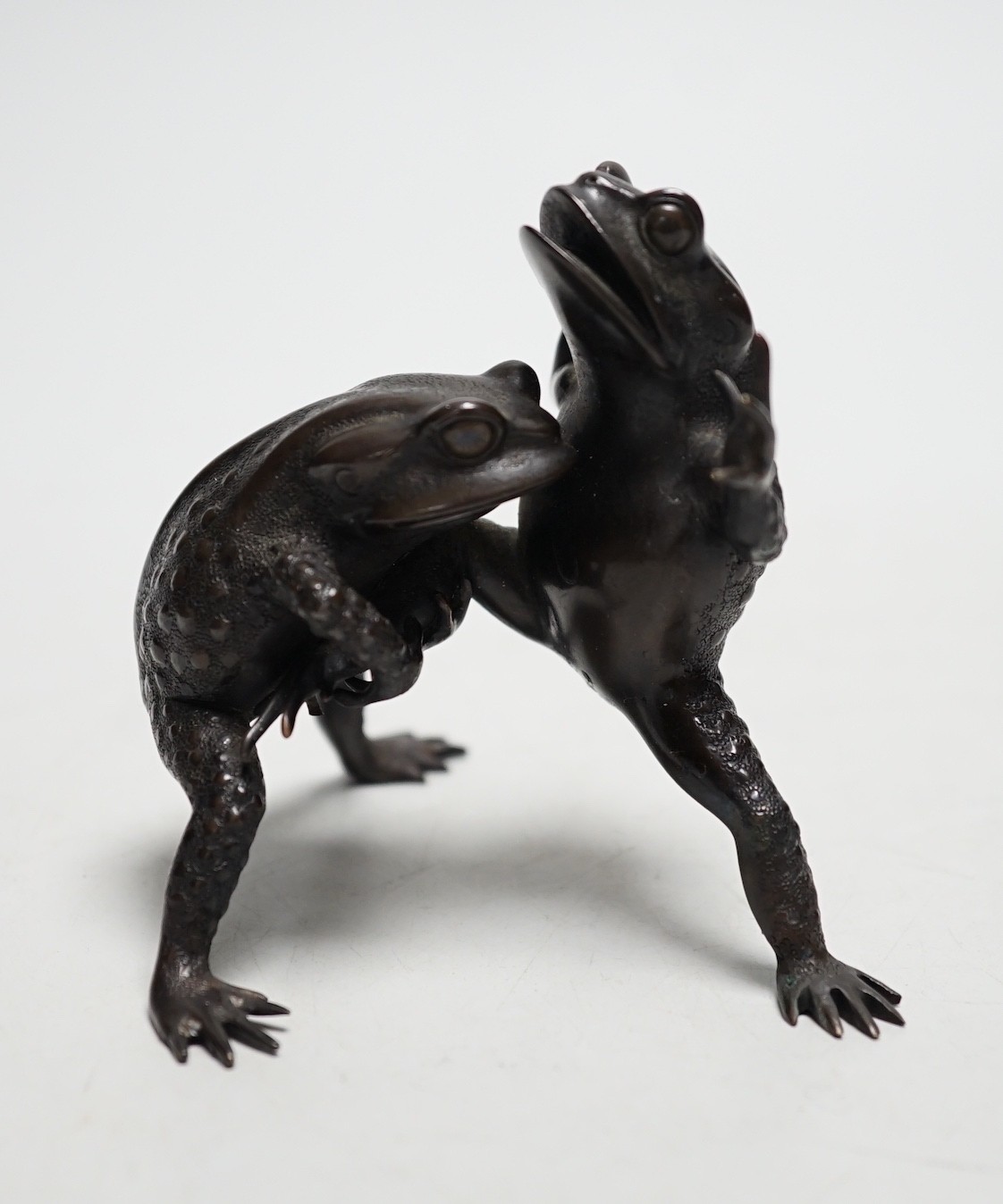 A Japanese bronze 'frogs' group, Meiji, 8cm tall
